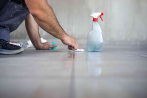 Concrete worker cleaning just built-in concrete patio.